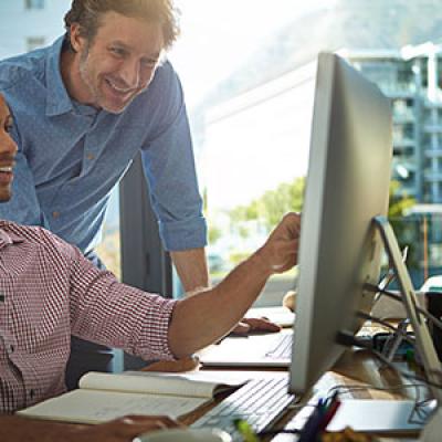 two men working at computer